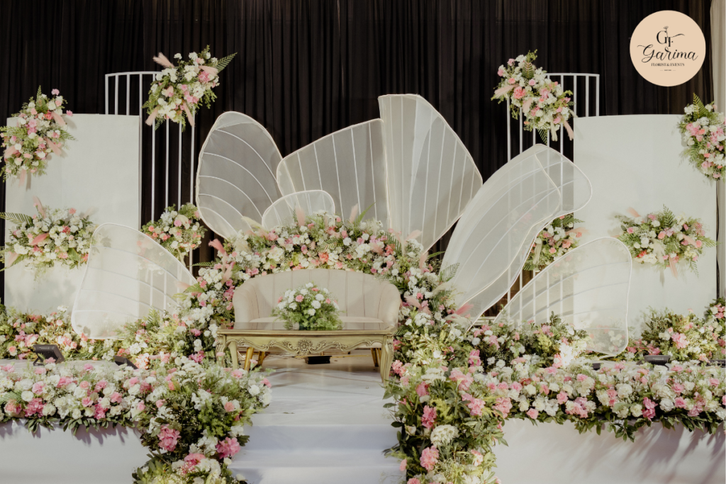 Wedding venue decorated with coordinated flowers, colors and lighting