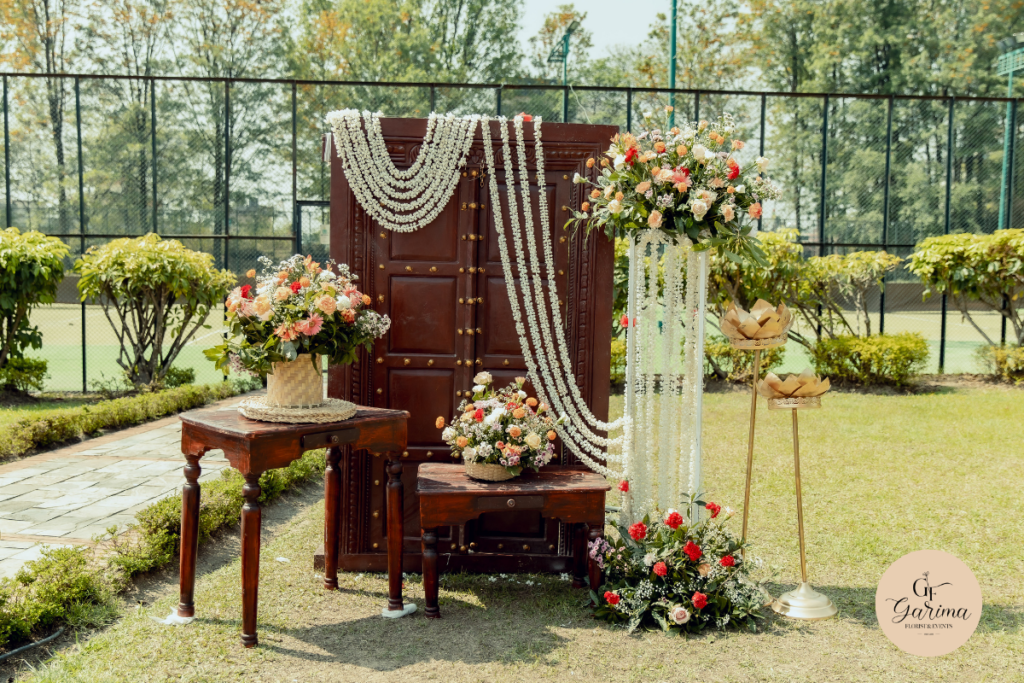 outdoor photobooth setup with flower arrangements