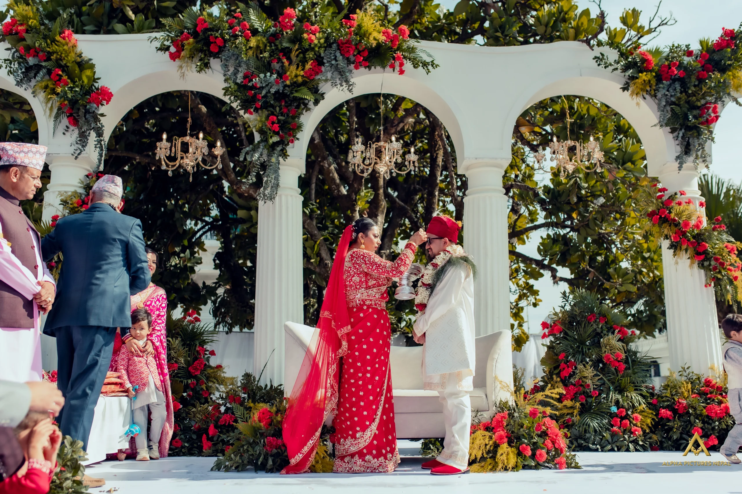 Red floral decoration at Pratima and Prithu wedding